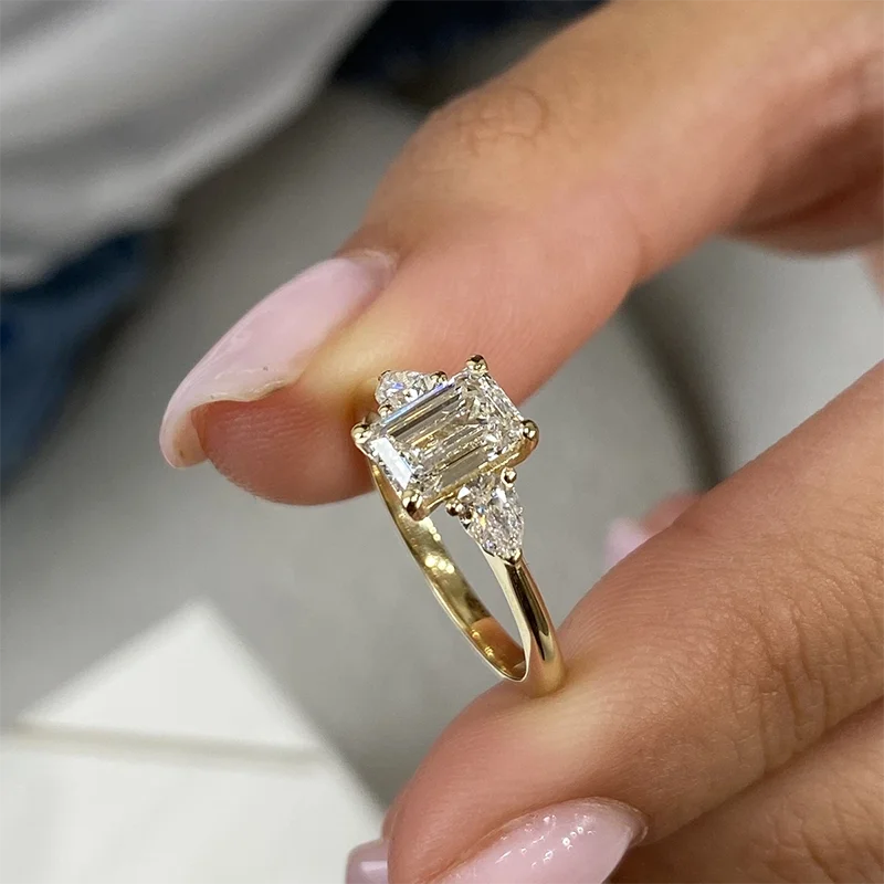 Lab-grown diamond ring with emerald-cut center stone