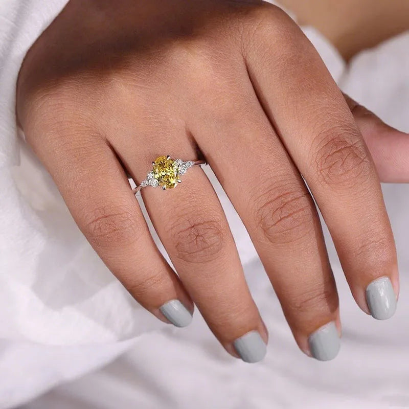 Oval yellow diamond ring with marquise and round accents