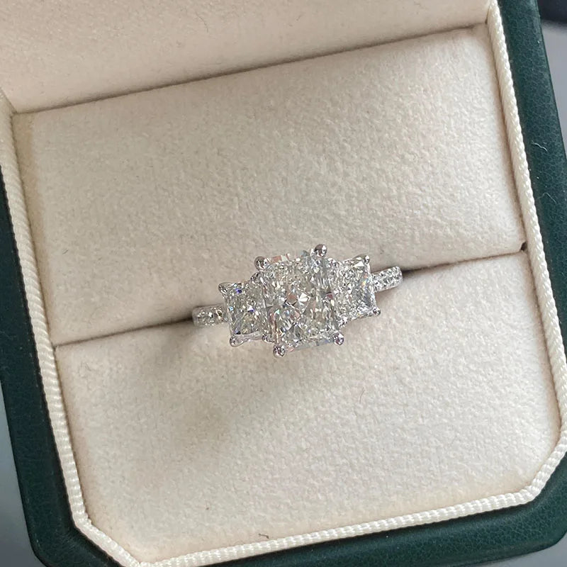Radiant diamond engagement ring with two side stones
