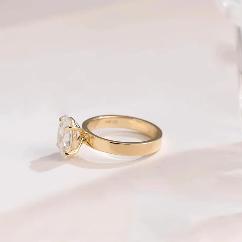 Prong-set oval-cut diamond ring with wide gold band