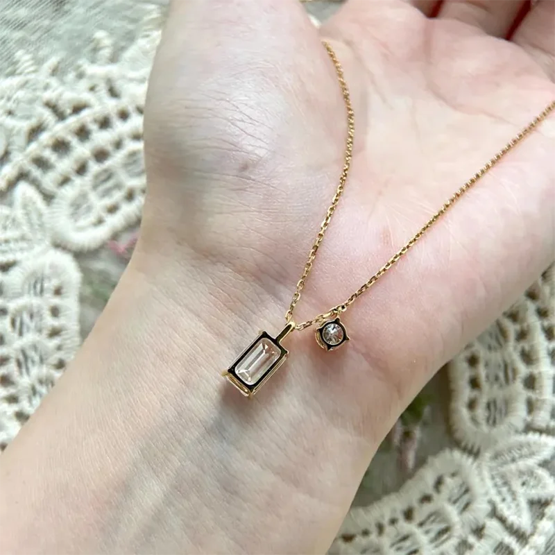 Lab-grown emerald and round diamond necklace