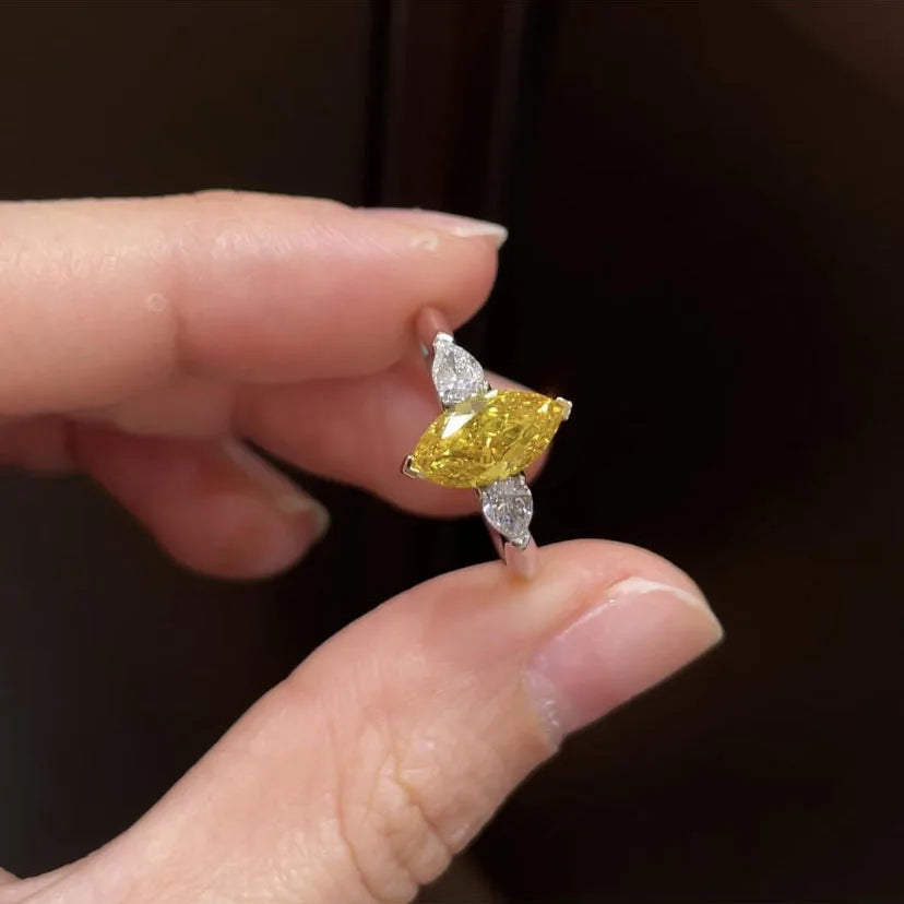 Three-stone yellow diamond engagement ring