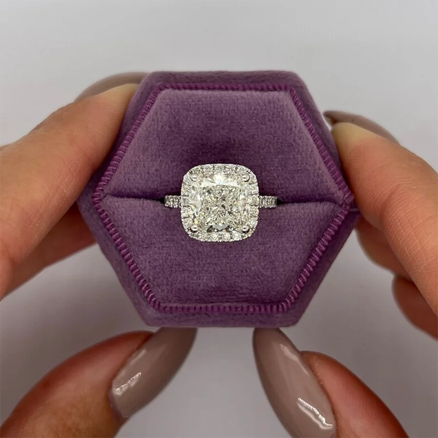 Cushion diamond engagement ring surrounded by diamond halo