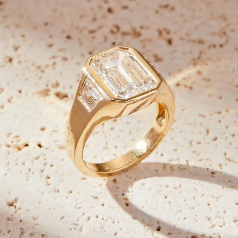 Three-stone emerald-cut diamond engagement ring