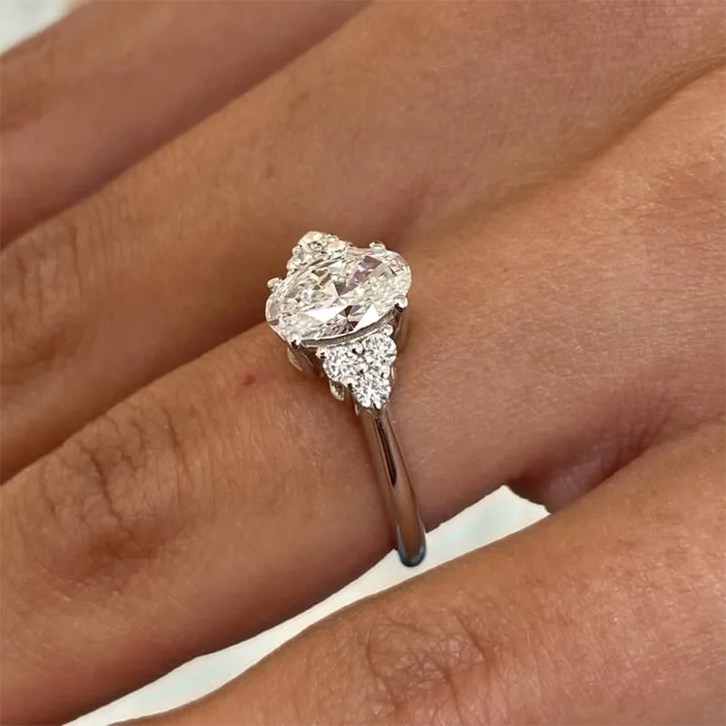Oval-cut lab-grown diamond ring with six round side stones