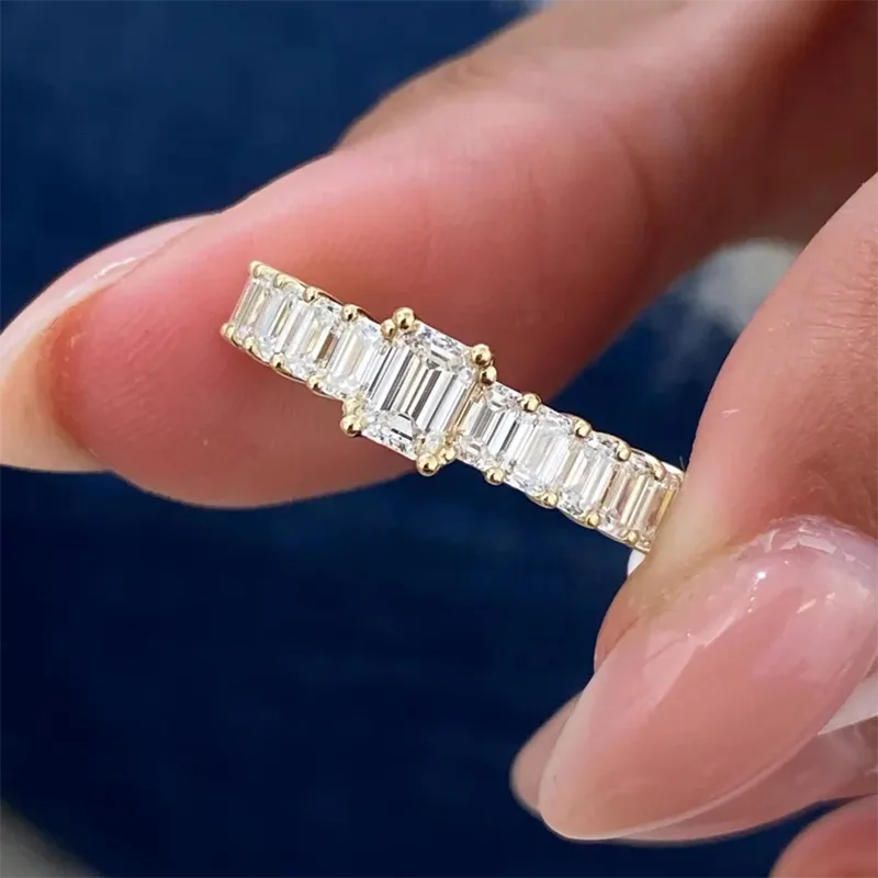 Gold diamond band with emerald-cut focal stone