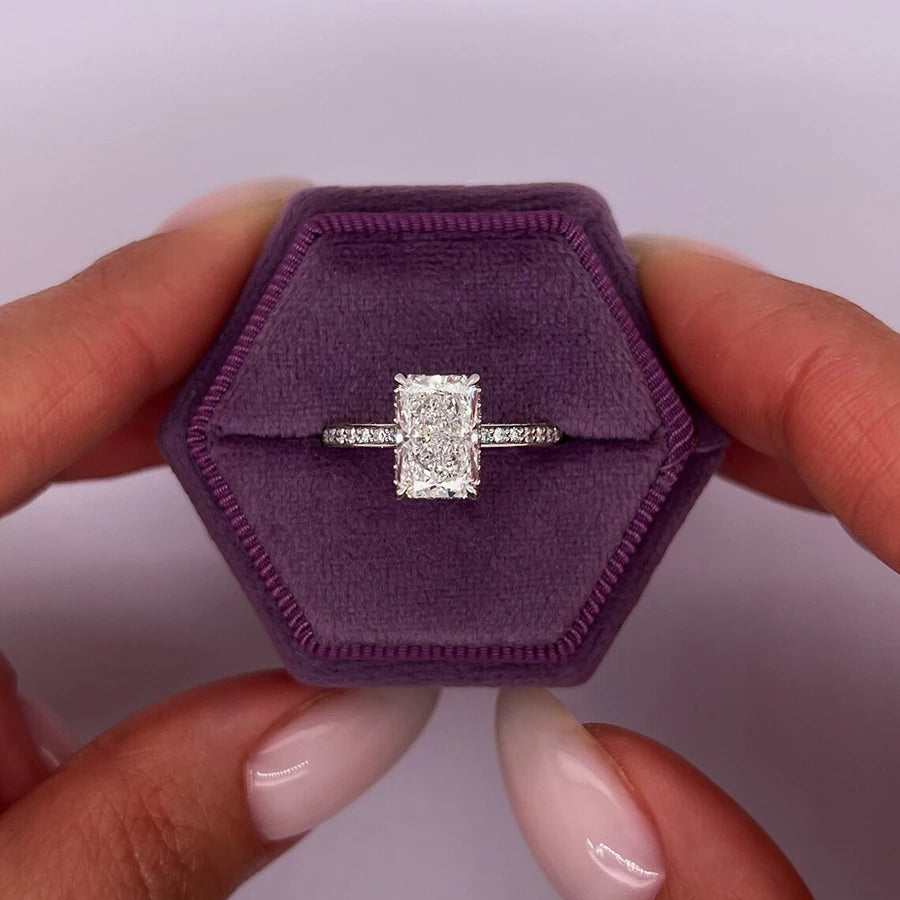 Radiant-cut lab-grown diamond halo ring with round diamond accents