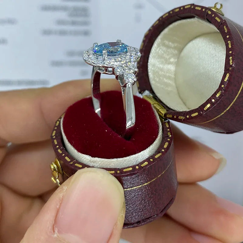 Prong-set blue oval diamond ring