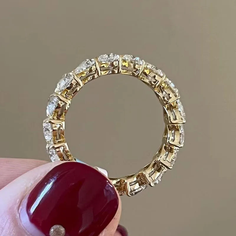 Gold eternity ring set with heart-shaped diamonds