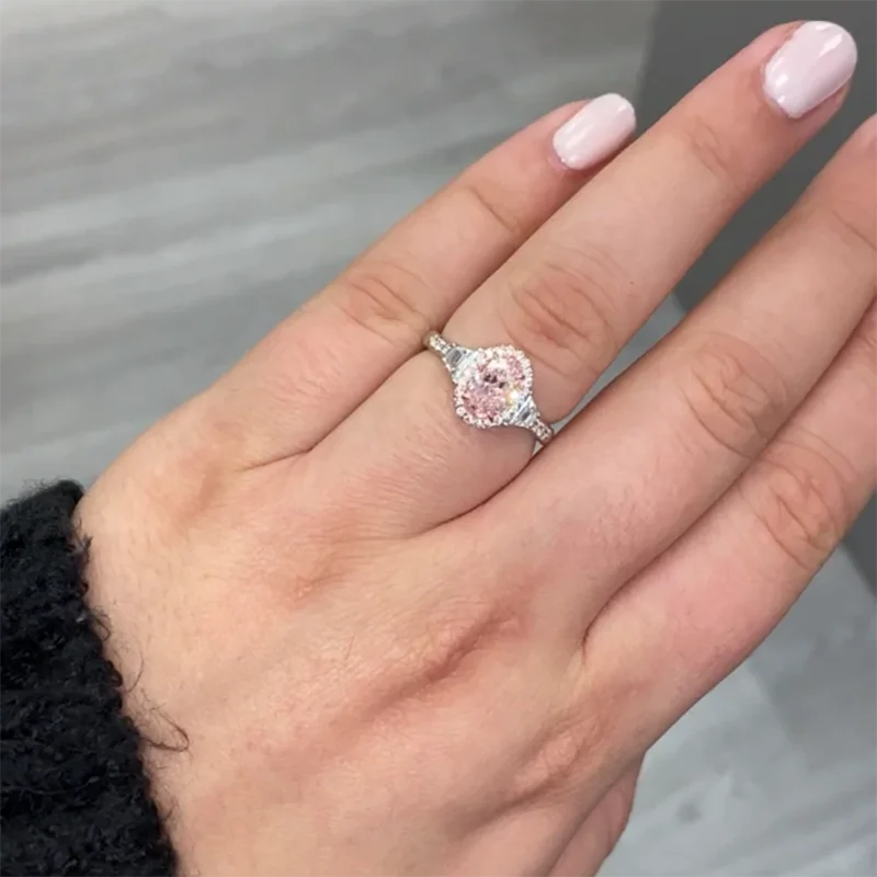 Pink oval-cut diamond ring with accents