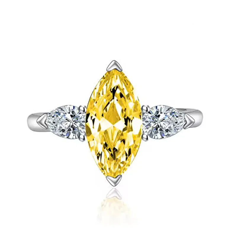 Yellow center diamond with two side diamonds in ring