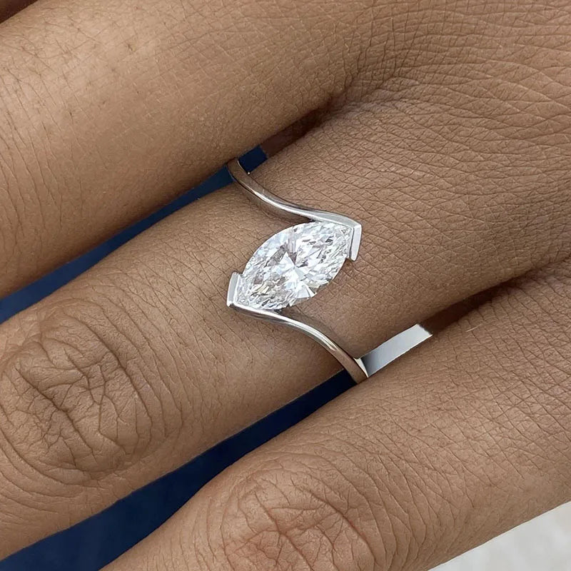 Twisting engagement ring with marquise-cut diamond