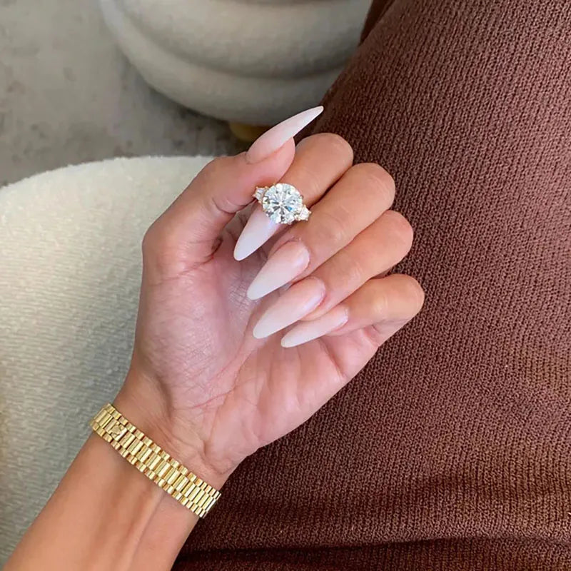 Three-stone lab-grown diamond ring with round center and baguette accents