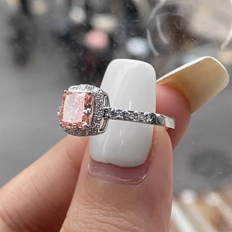 Pink cushion diamond framed by a halo of diamonds