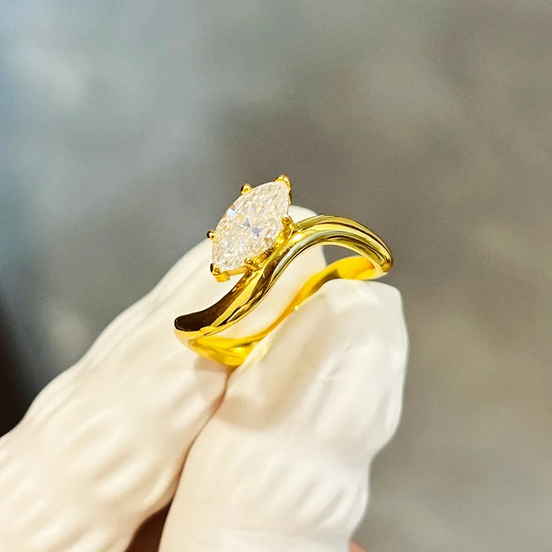 Wave-style engagement ring featuring marquise diamond