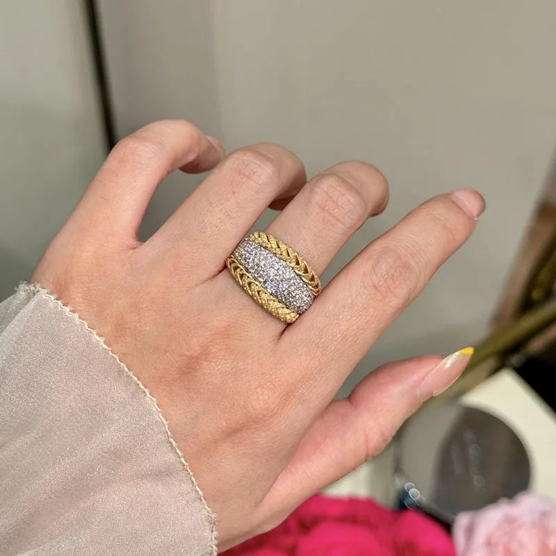 Eighteen carat gold twisted band with diamond accents