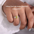 Fancy yellow oval lab-grown diamond ring with accent stones