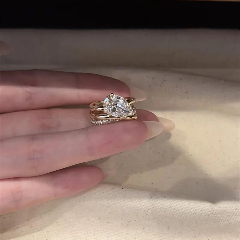 Multi-layered gold engagement ring with pear lab-grown diamond