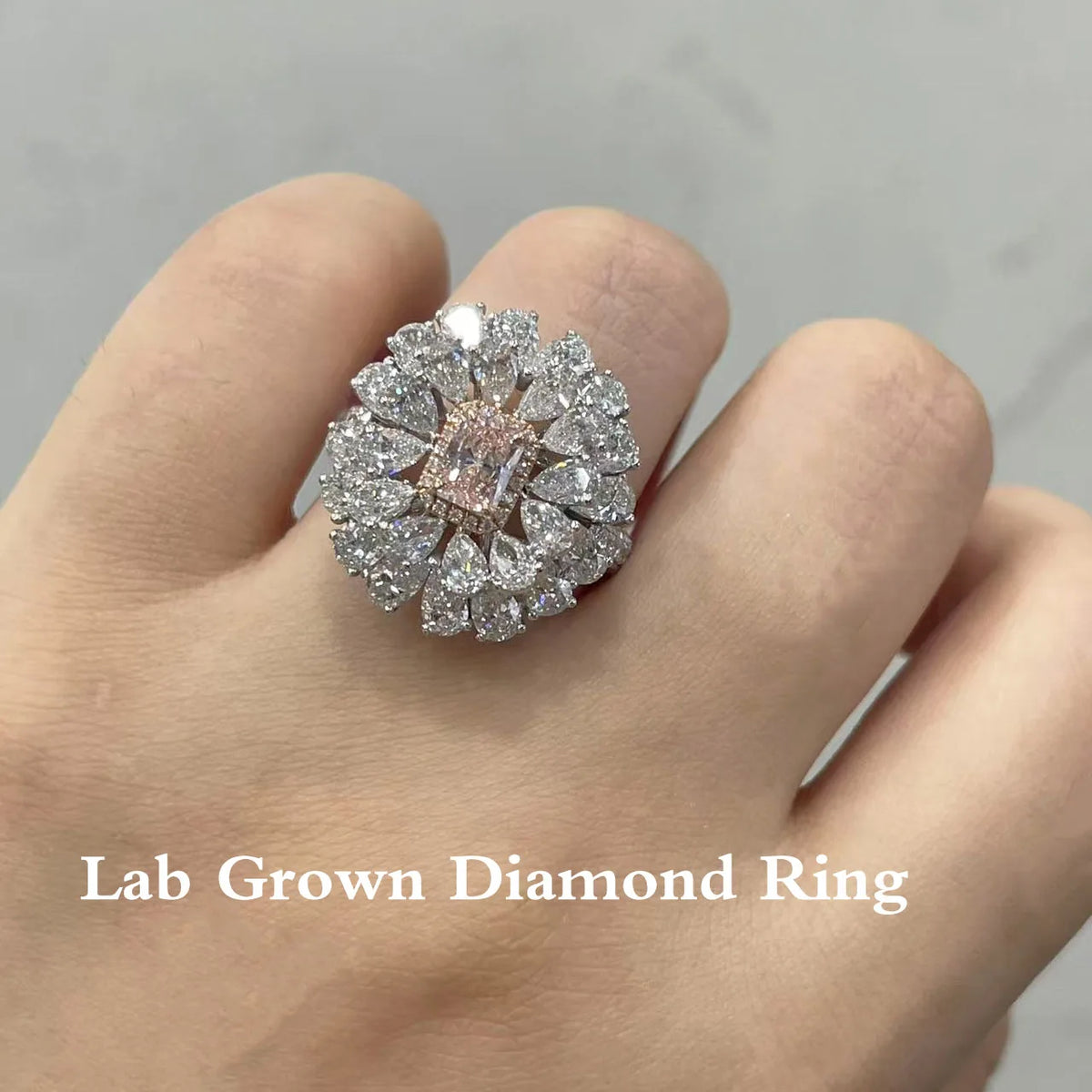Pink radiant lab-grown diamond ring with pear diamond accents